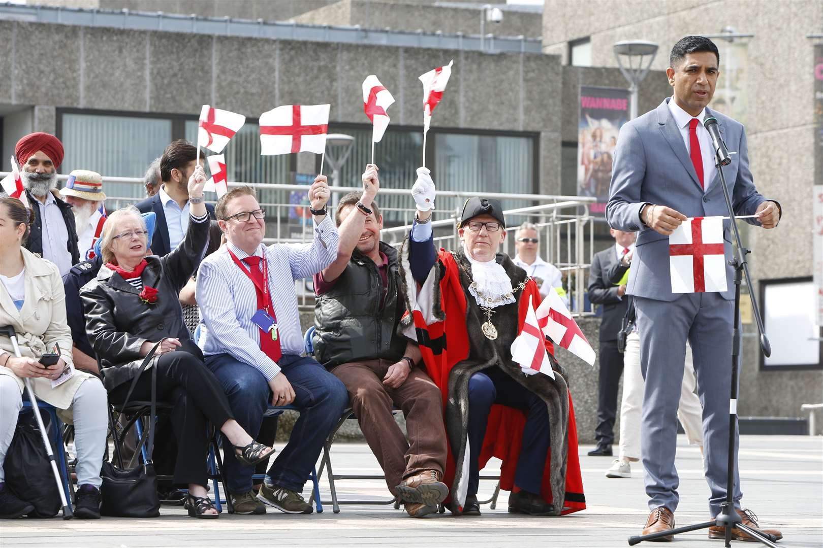 Gurvinder Sandher, artistic director at Cohesion Plus, speaks at the St George's Day parade in Gravesend