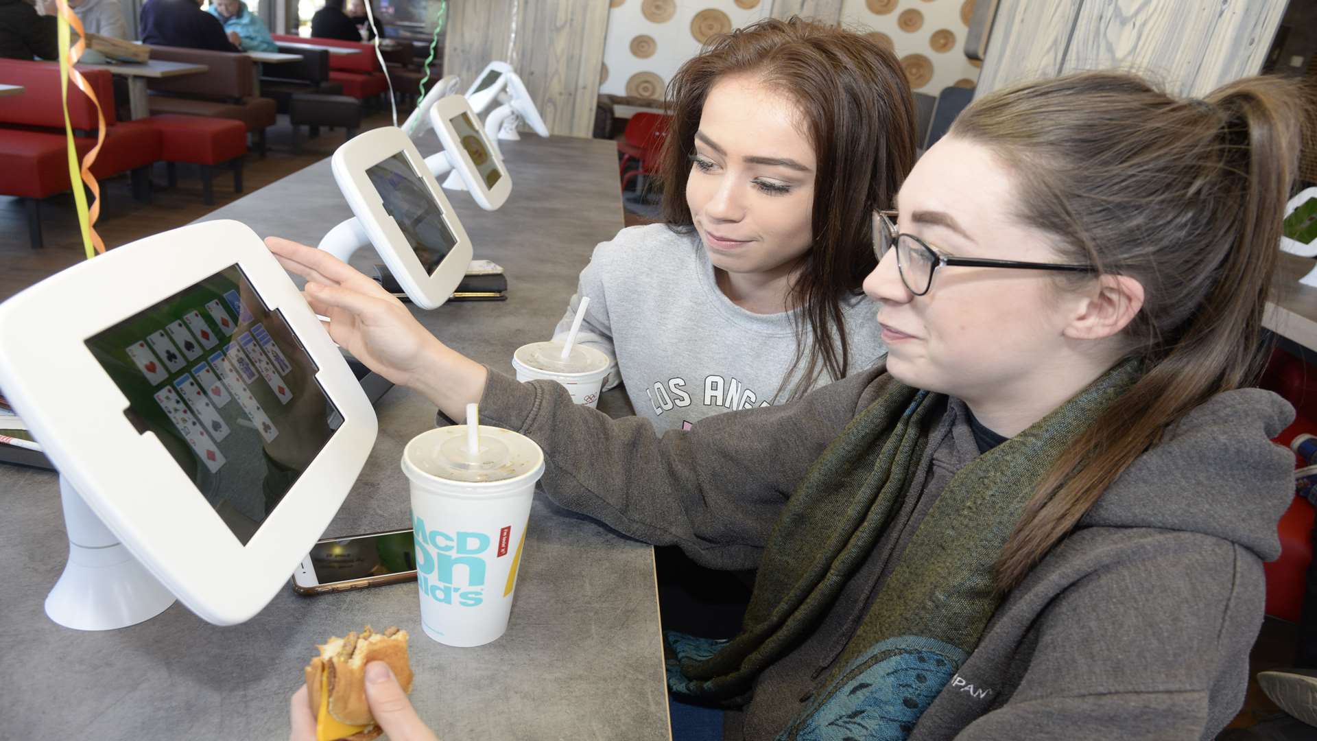 Paige Luton and Chelsea Blyth use one of the tablets at the newly refurbished Chestfield McDonald's.