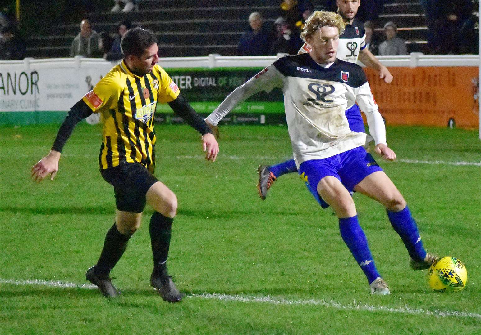 Charlie Dickens clears his lines for Faversham under pressure from Folkestone's Ian Draycott. Picture: Randolph File
