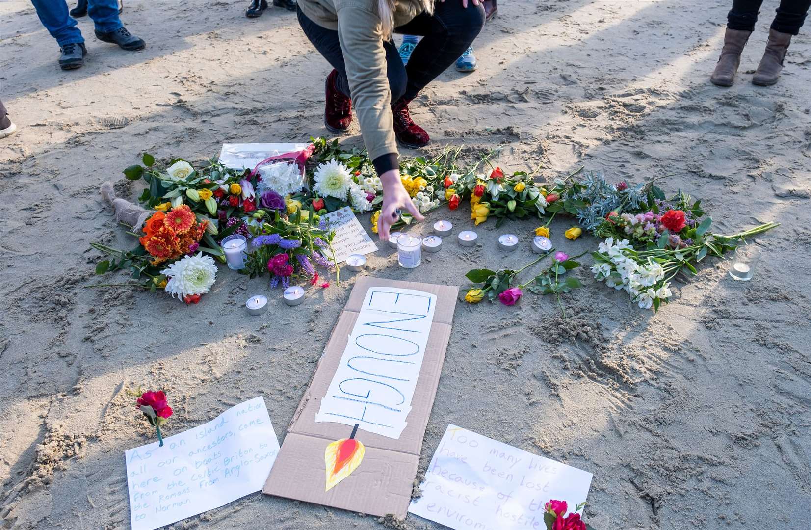 Flowers and candles laid at the vigil on Sunny Sands beach in Folkestone. Picture: Andy Aitchison