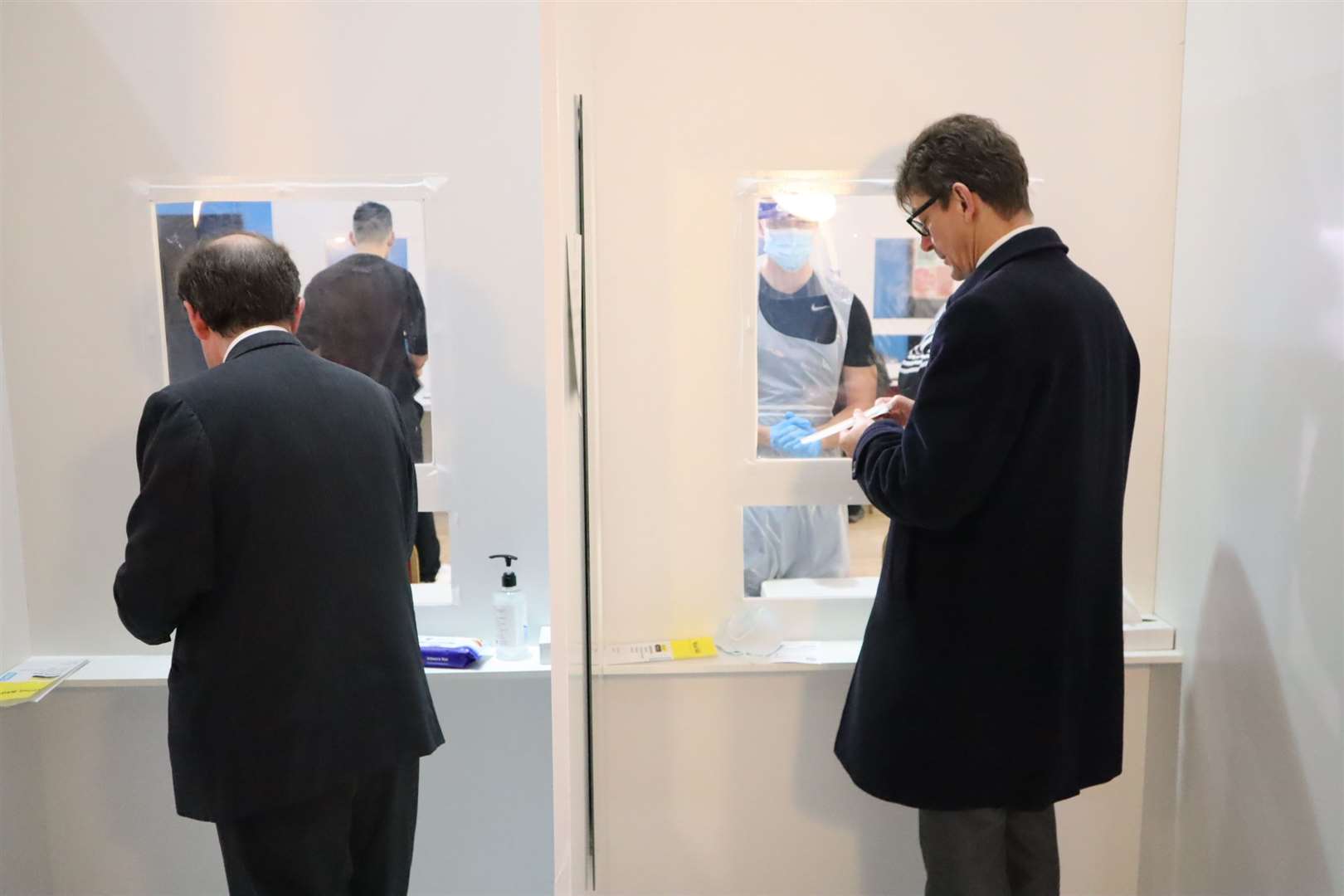 KCC leader Roger Gough, left, and Kent's director of public health Andrew Scott-Clark undergo a Covid test in Sheerness East WMC, Halfway, which opens as a mass public test centre on Friday