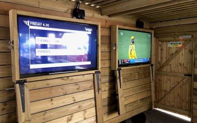 These large screens, in protective boxes, are on the wall of the smoking area at the front of the pub