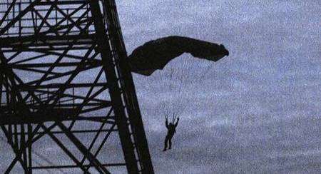 A man paraglides from the top of Dunkirk Tower on Monday evening.