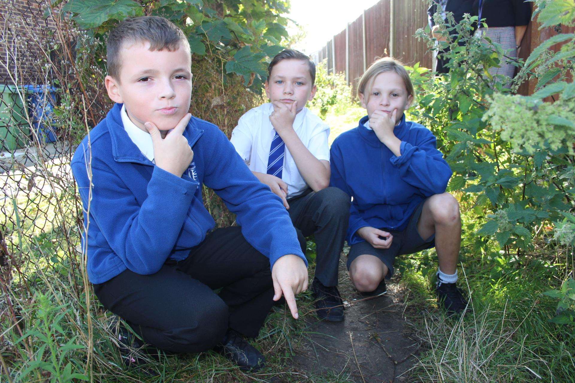 Ten-year-olds Tate, Kieran and Jenson in the alley where they found two machetes near Halfway House Primary School, Minster, Sheppey