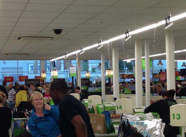 Rain gushes through the ceiling at Asda in Sittingbourne. Picture: @kent_999s/Laura Snare