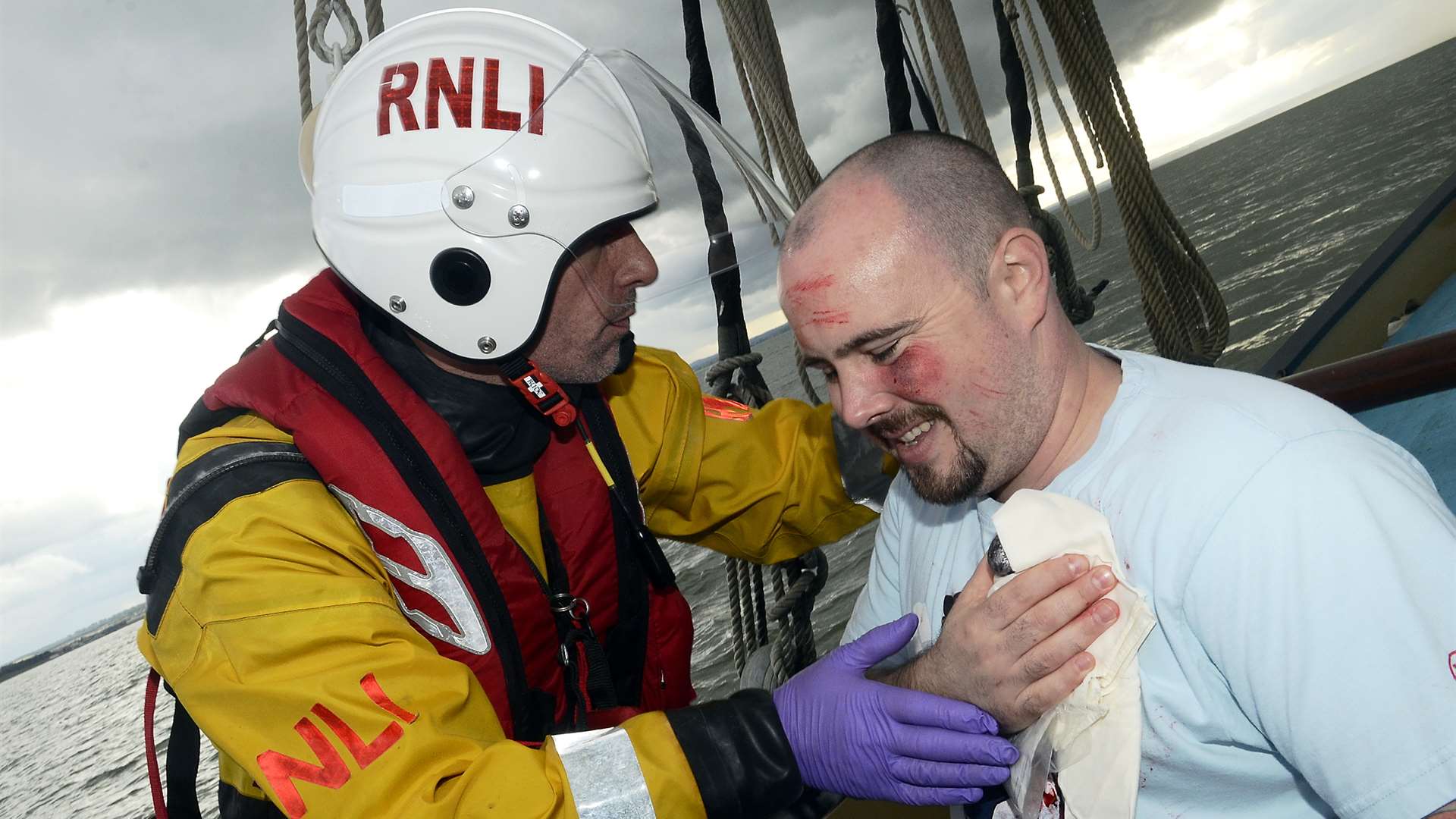 Lifeboat volunteer Matt Bate helps Scott Goudie during the exercise