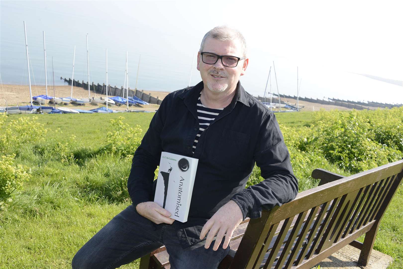 Andrew McGuinness with his new novel. Picture: Paul Amos