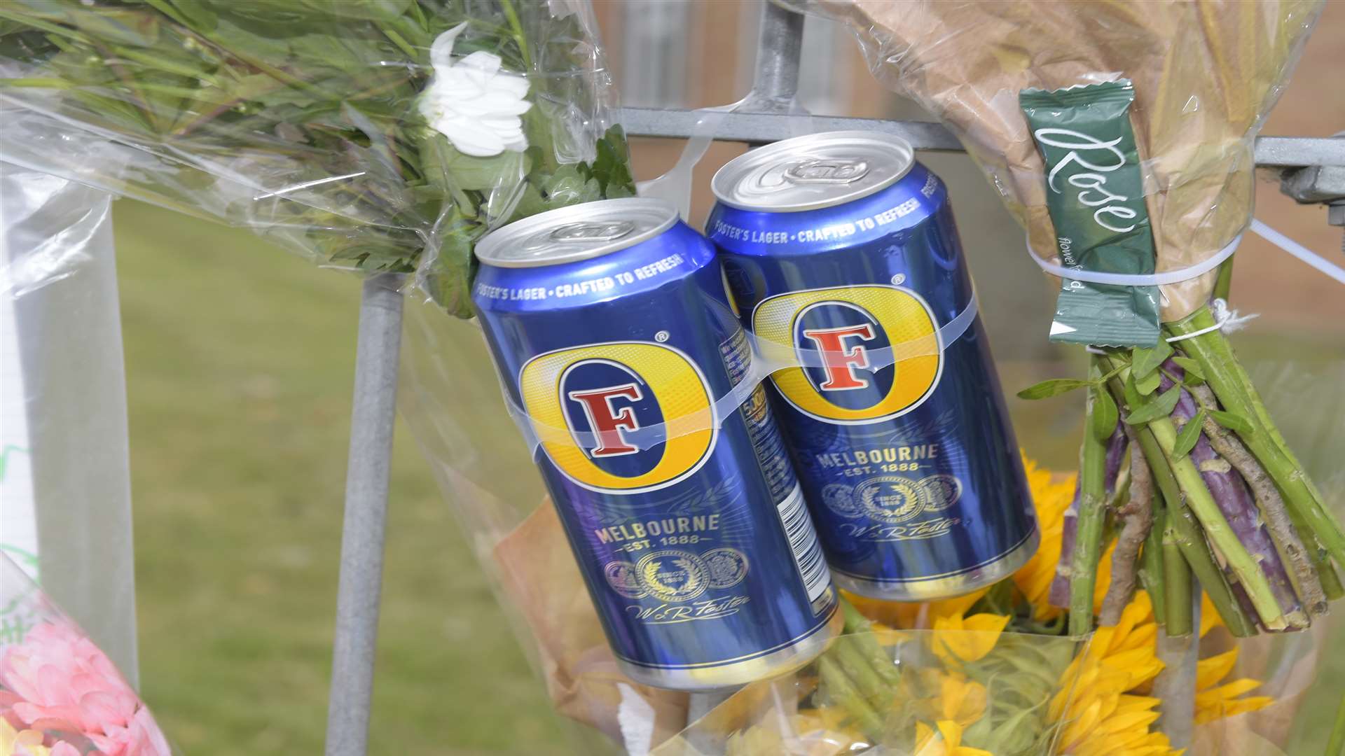 Drinks cans were left among the floral tributes