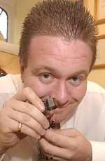 RESPECTED: Michael Baker checking a diamond he donated to charity in 2002