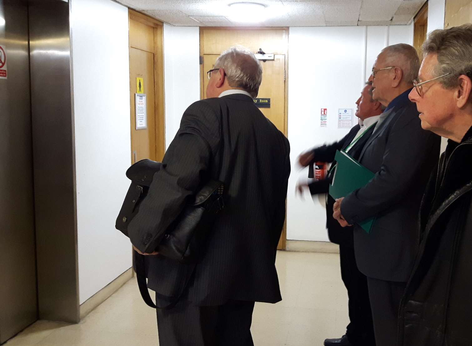 Trying to help: Swale councillors including council leader Andrew Bowles, left, and Adrian Crowther, right, study the rogue lift