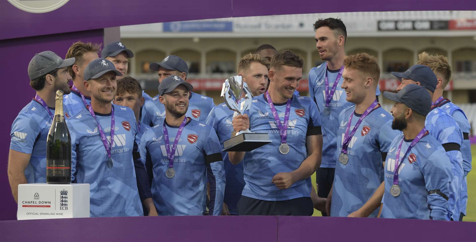 No shortage of smiles from the Kent Spitfires as the trophy is passed around. Picture: Barry Goodwin