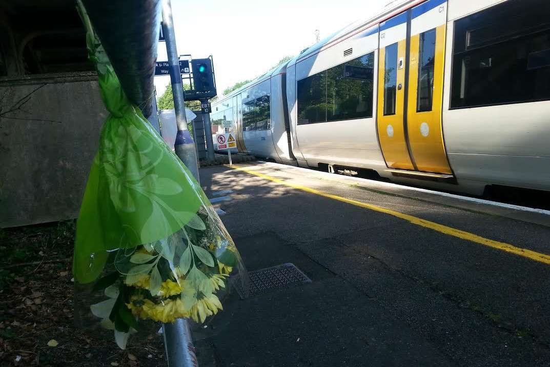 A single bouquet of flowers by the railway line after the tragedy at Chartham train station