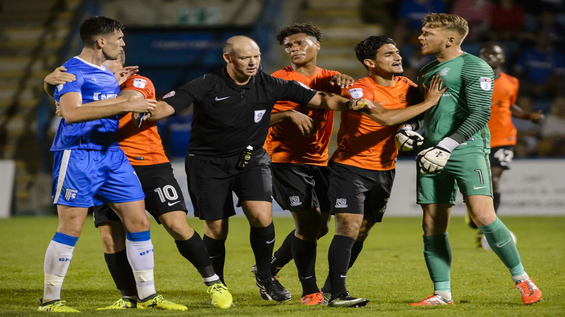 Referee Andy Haines keeping Gillingham and Southend players apart Picture: Andy Payton