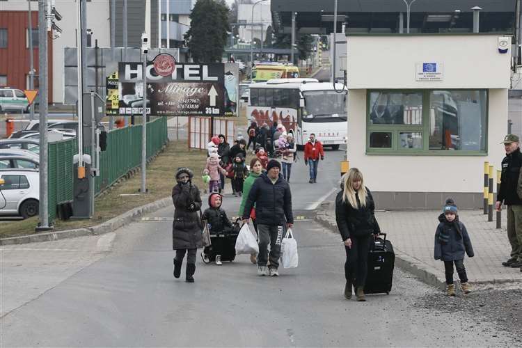 People arrive at a border crossing in Medyka, Poland. Picture: Visar Kryeziu/AP/PA