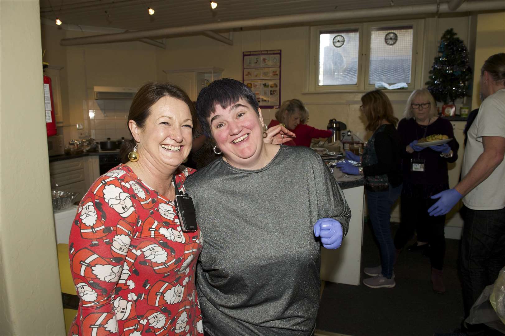 (left) Elizabeth Shaw and volunteer Michelle Langley. at the One Big Family Christmas Party.