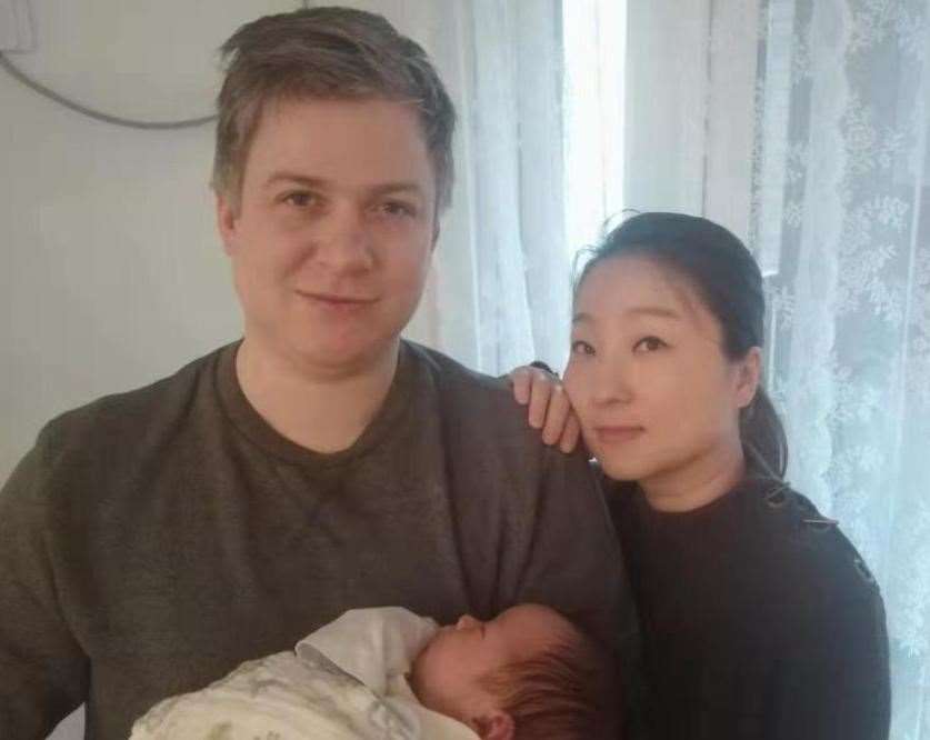 Adam Bridgeman with his wife Su and baby Austin.