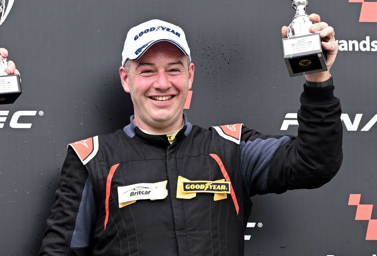Bradley celebrates his Britcar Trophy race win on the podium. Picture: Simon Hildrew
