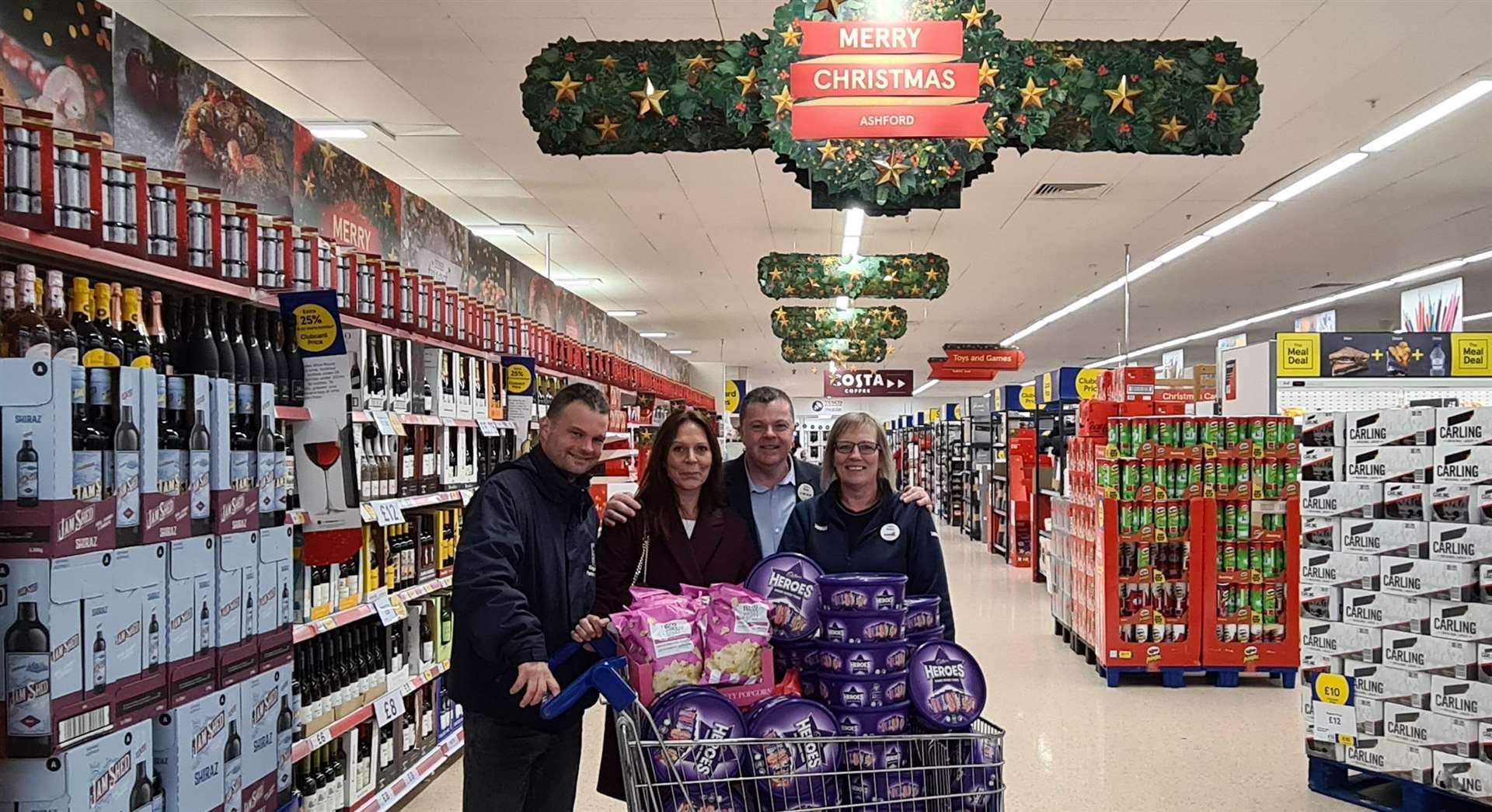 Peter Le Rossignol and Marie Russell from Kingsnorth Parish Council with Nick Fox and Jenny Drapper from Tesco with the free chocolates and popcorn for the drive-in families