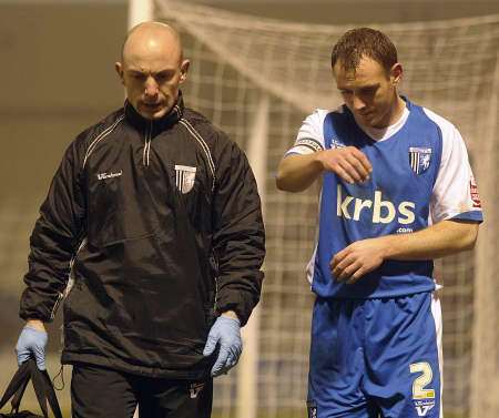 Barry Fuller leaves the pitch against Leyton Orient with an injured arm