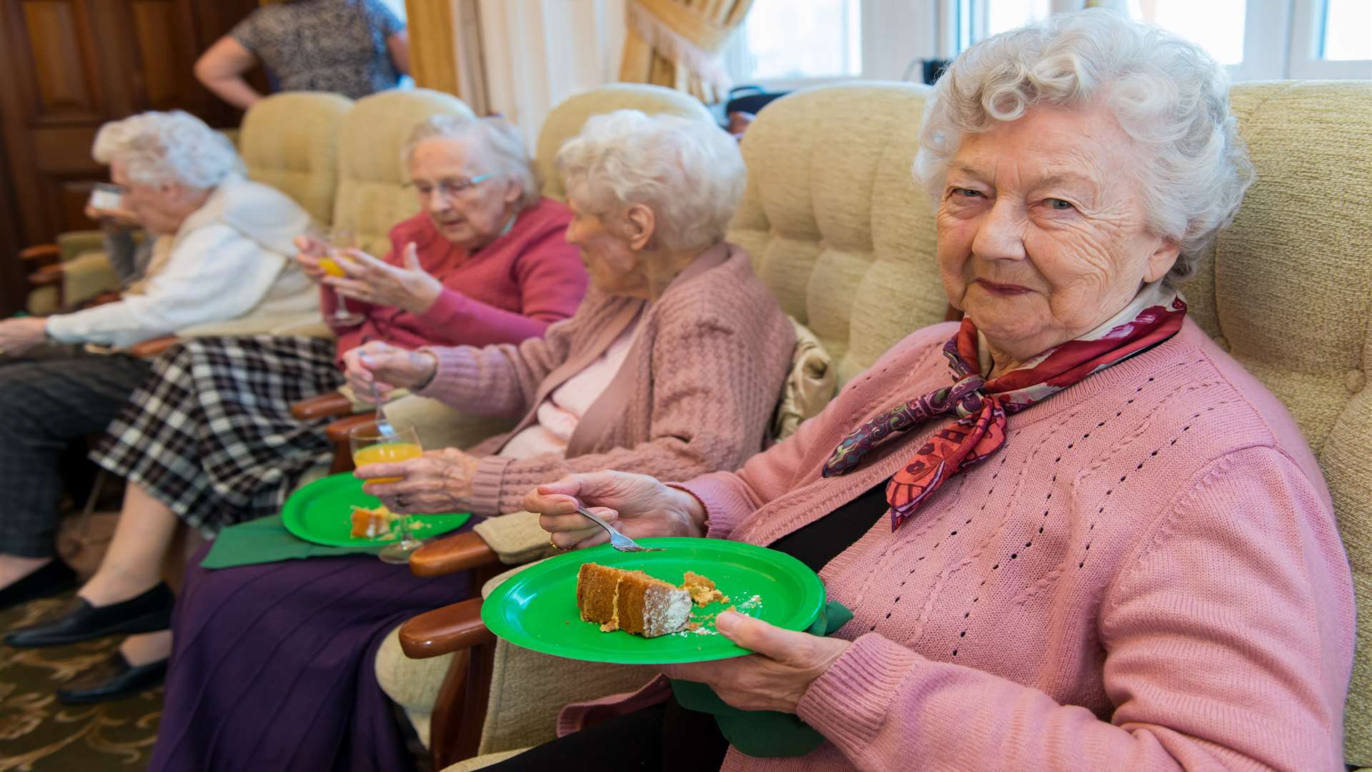 Residents enjoy a slice of cake and a bucks fizz at the event.
