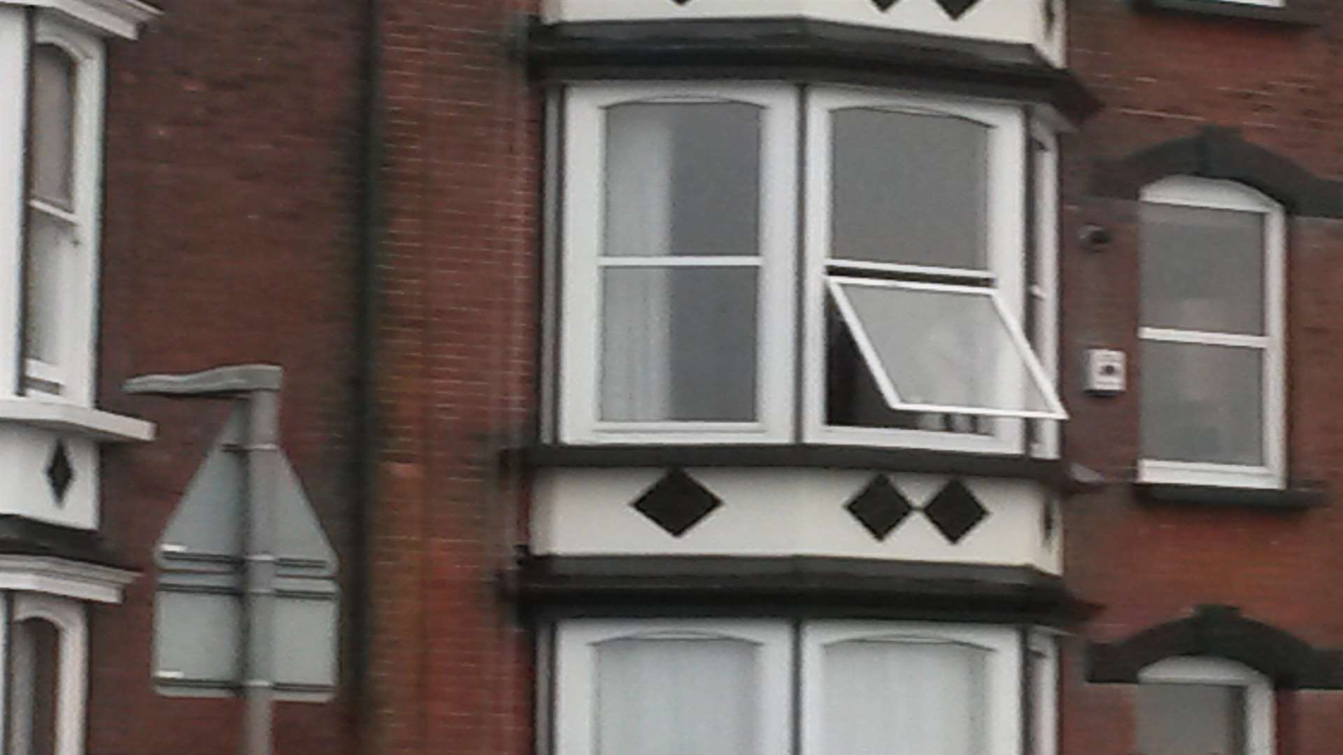 A man has been seen brandishing a knife from a first floor window