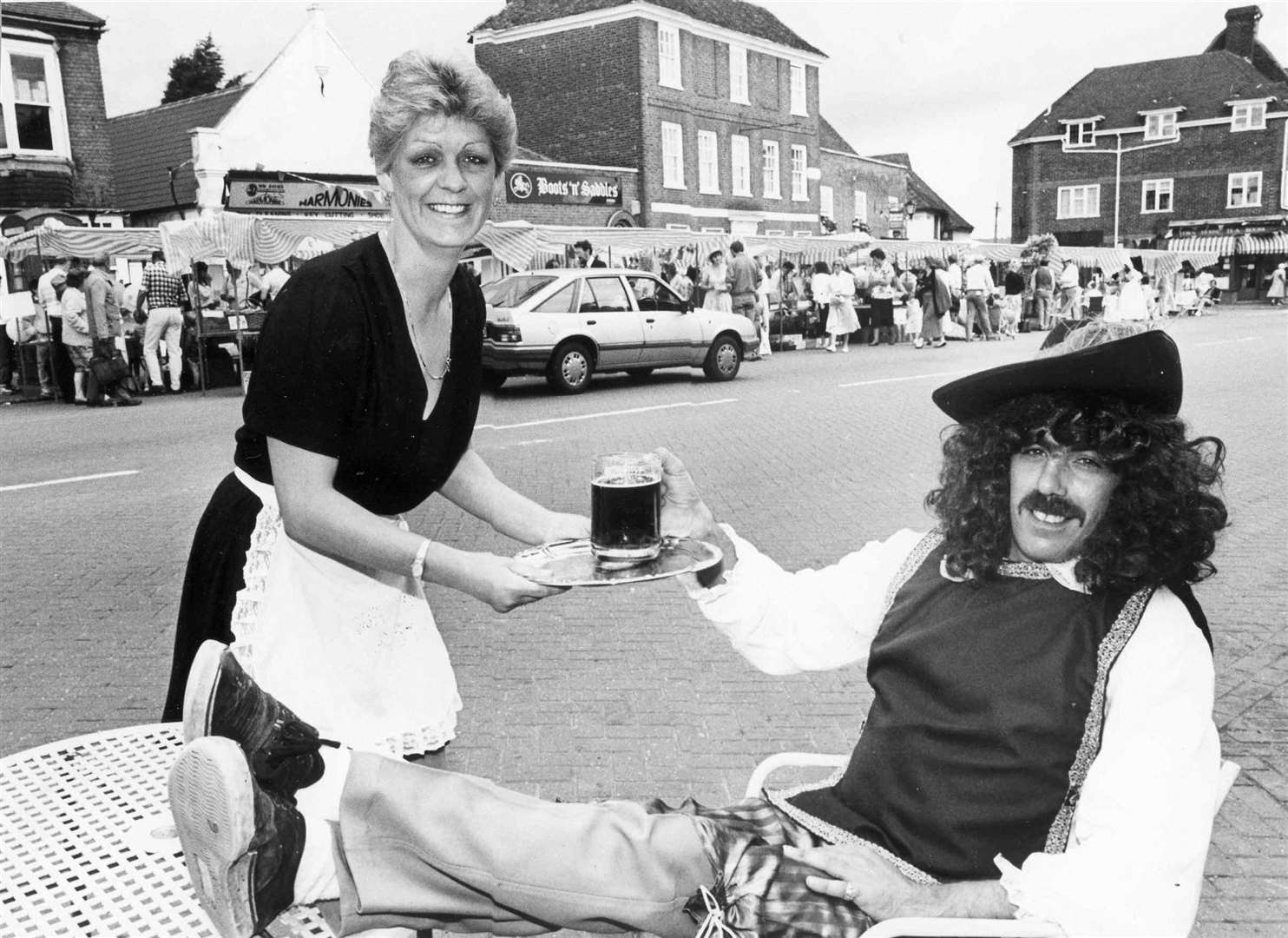 Sandra Hartman, landlady of The Bear, serves beer to her husband, a dandy for the day at the Dickens Festival in West Malling High Street in July 1988. It has since been renamed The Farmhouse