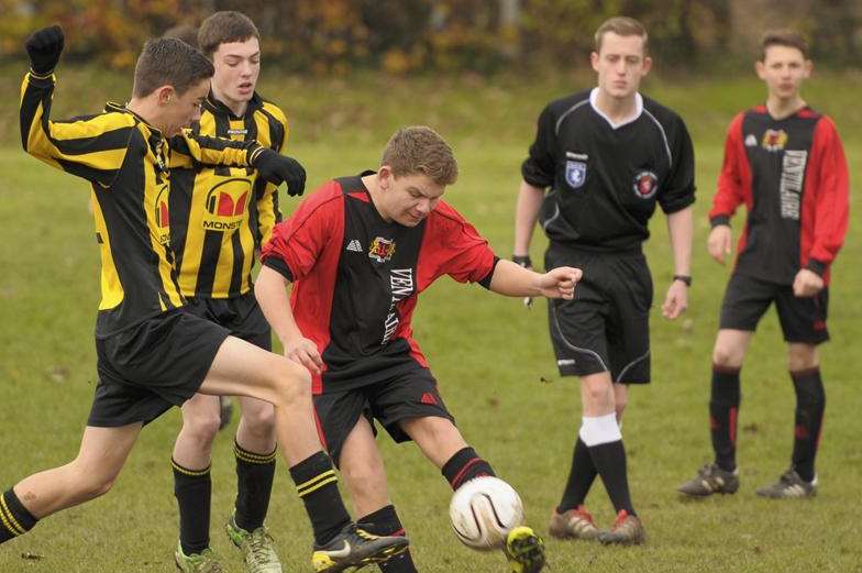 Woodcoombe Youth, in red, battle Rainham Eagles United in Under-14 Division 1. Picture: Andy Payton