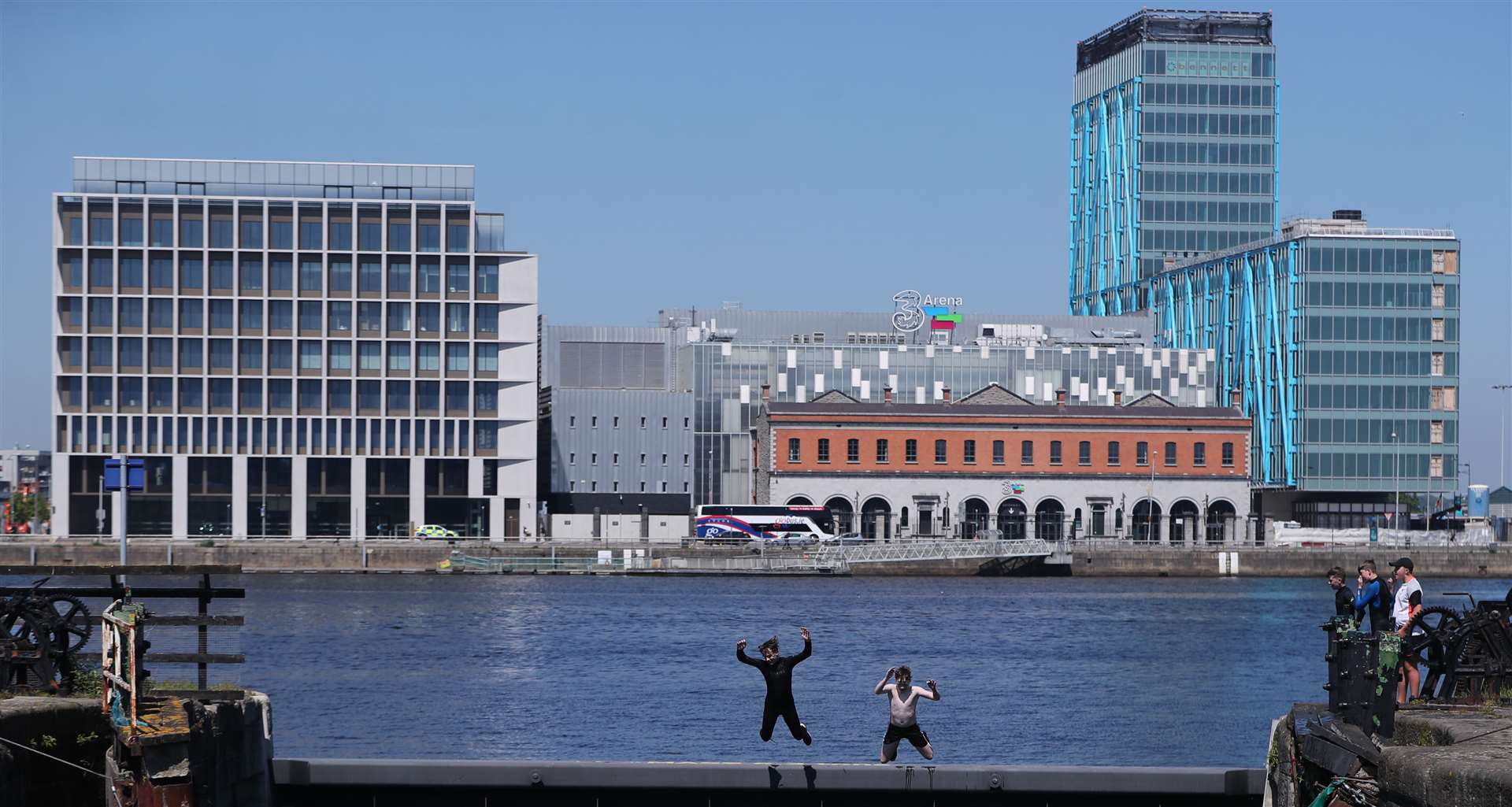 Young people jump into the Grand Canal in Dublin as temperatures rise (Niall Carson/PA)