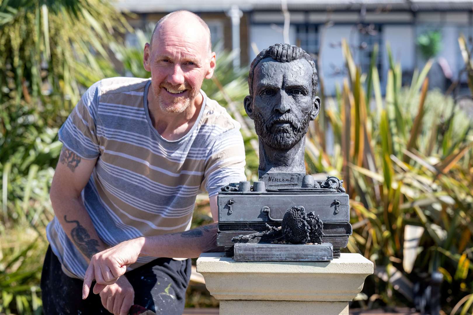Carl Stafford with bust of Vincent Van Gogh that is only a few hundred meters from his home. Picture: SWNS