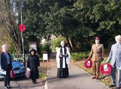 The Rev David Trustram with wreath layers at the Sutton Valence Remembrance Service