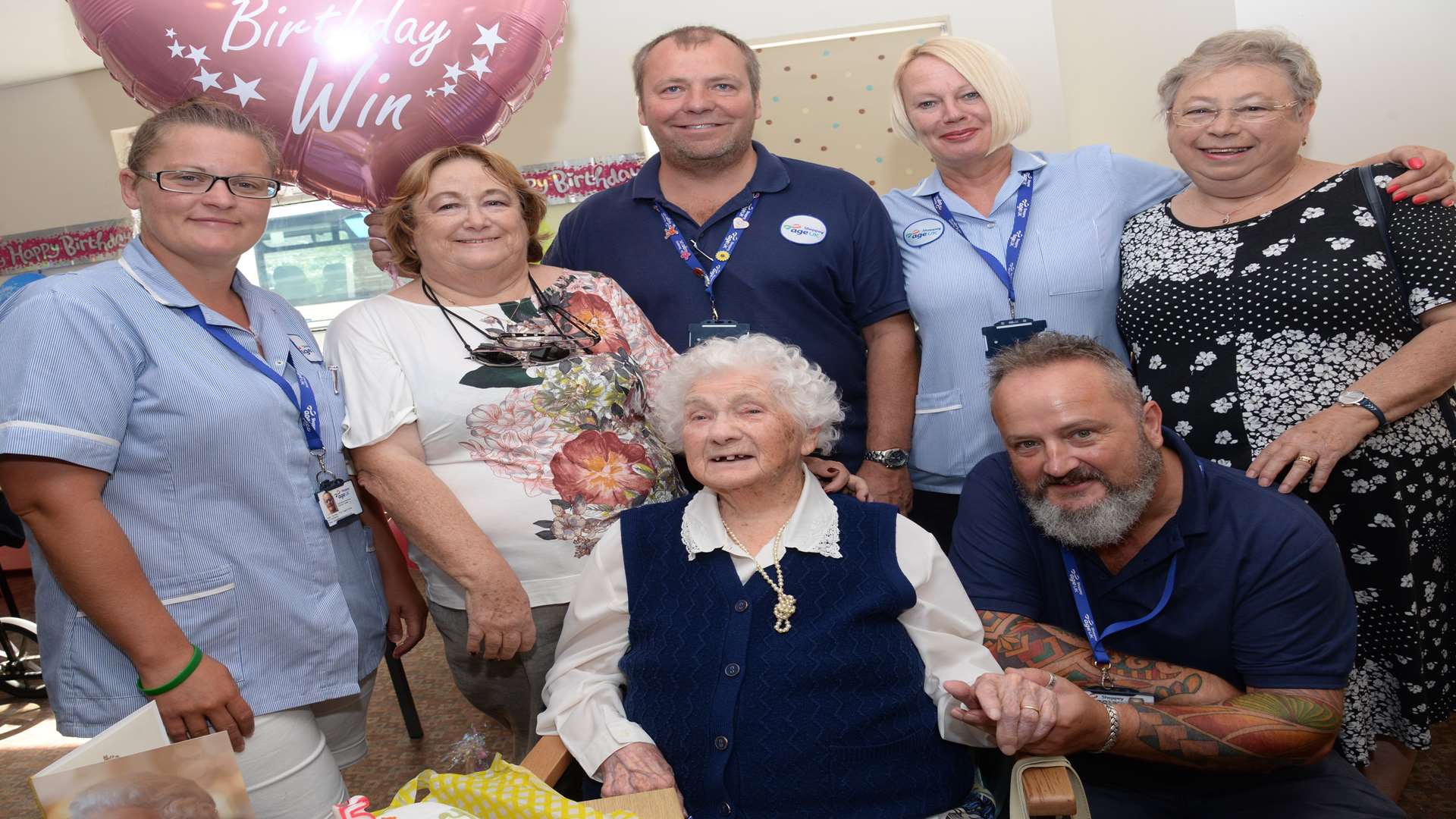 Winifred Kemp celebrates her 105th birthday at Age UK with some of the staff, and daughters Linda Neal and Christine Webb