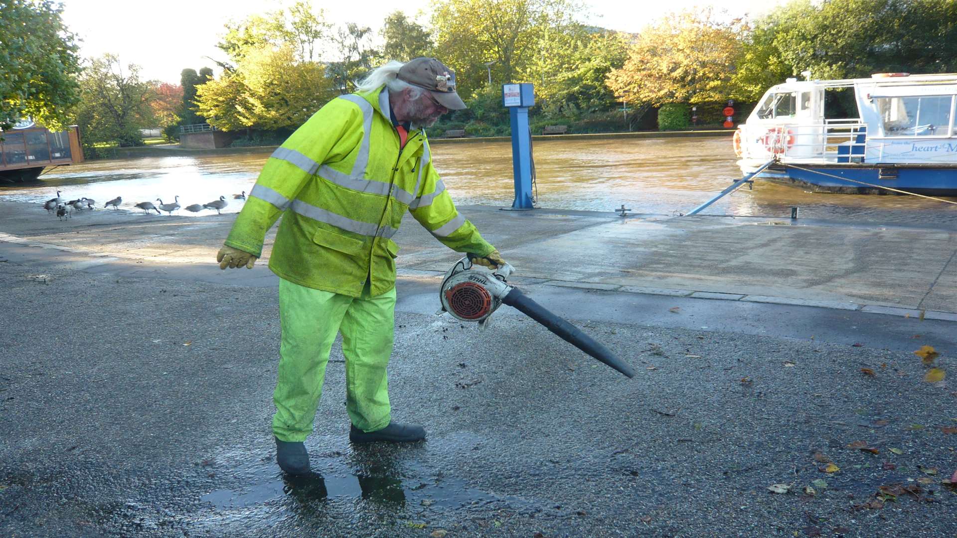 A council worker clearing leaves near the River Medway