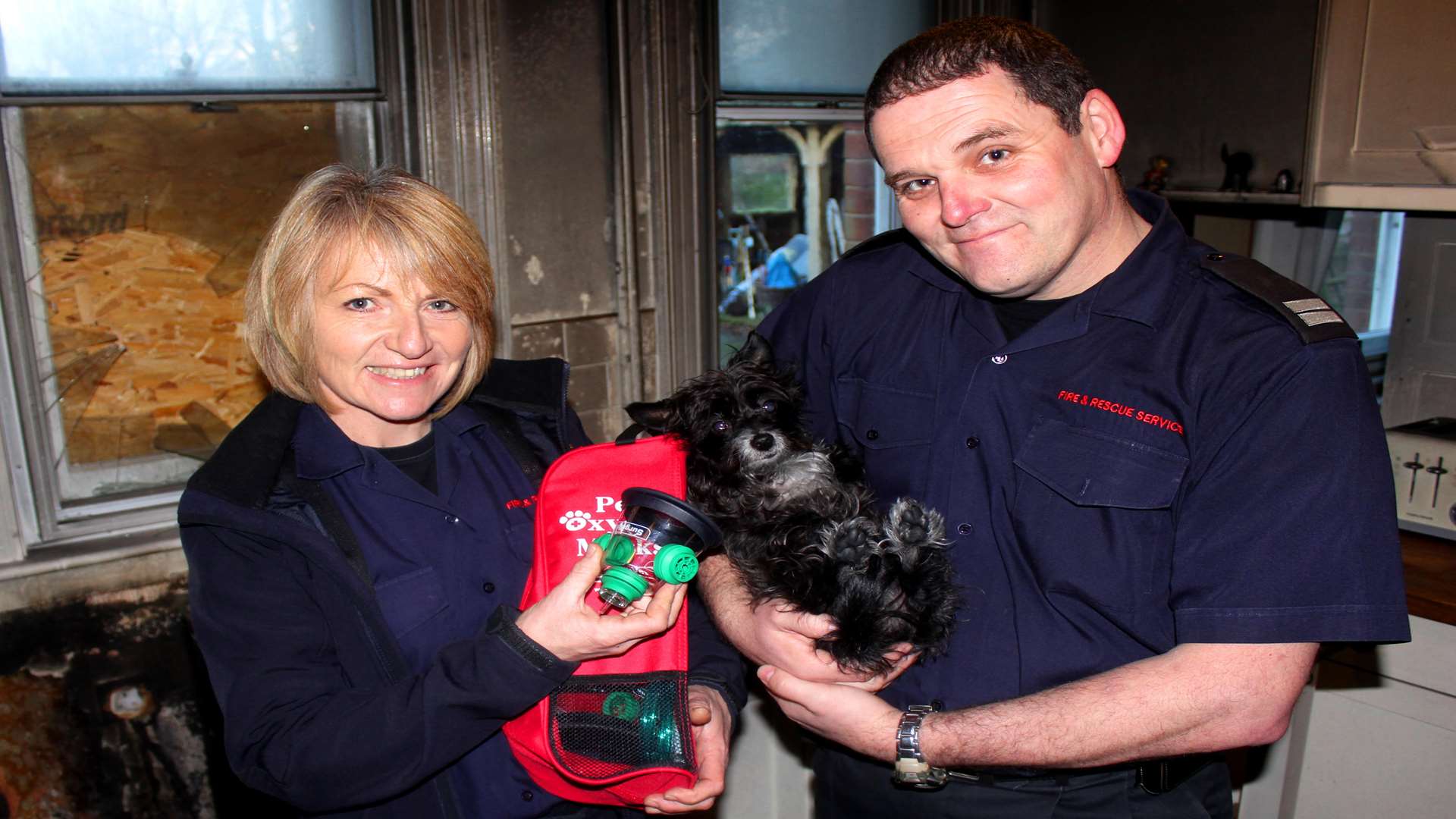 Maggie with firefighter Louise Ayley and Faversham Crew Manager Wayne Burney. Picture: Kent Fire and Rescue Service