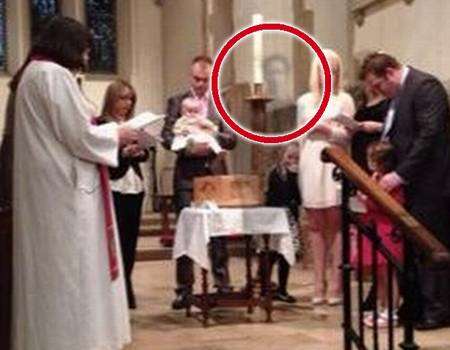 The ghostly figure, circled, in the photograph taken during the christening service in St Martin’s Church, Canterbury