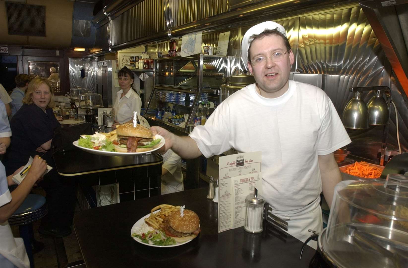 Neil Collins serving burgers in the former American diner next to Bybrook Barn in April 2002