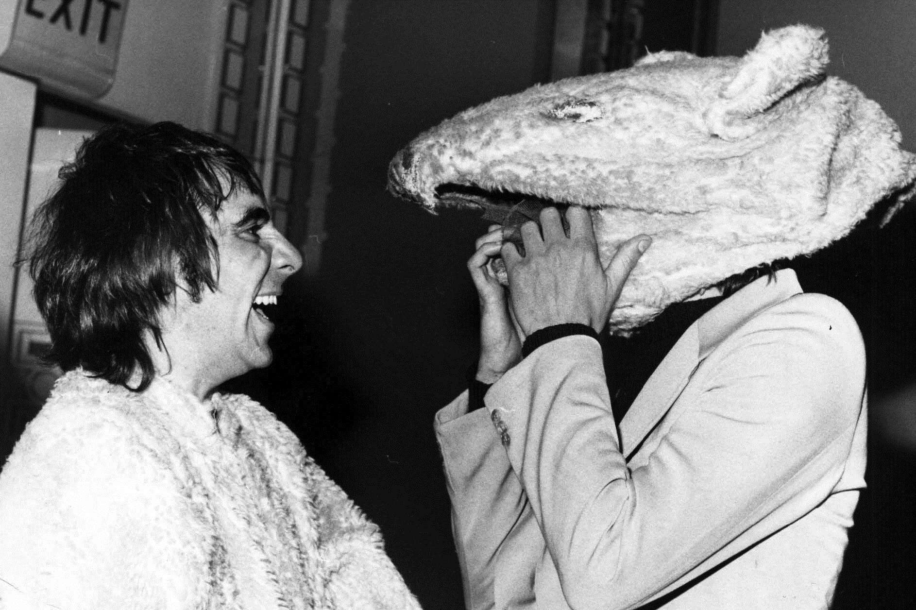 Always joking, The Who's wild drummer Keith Moon has placed a bear's head on Pete Townshend.