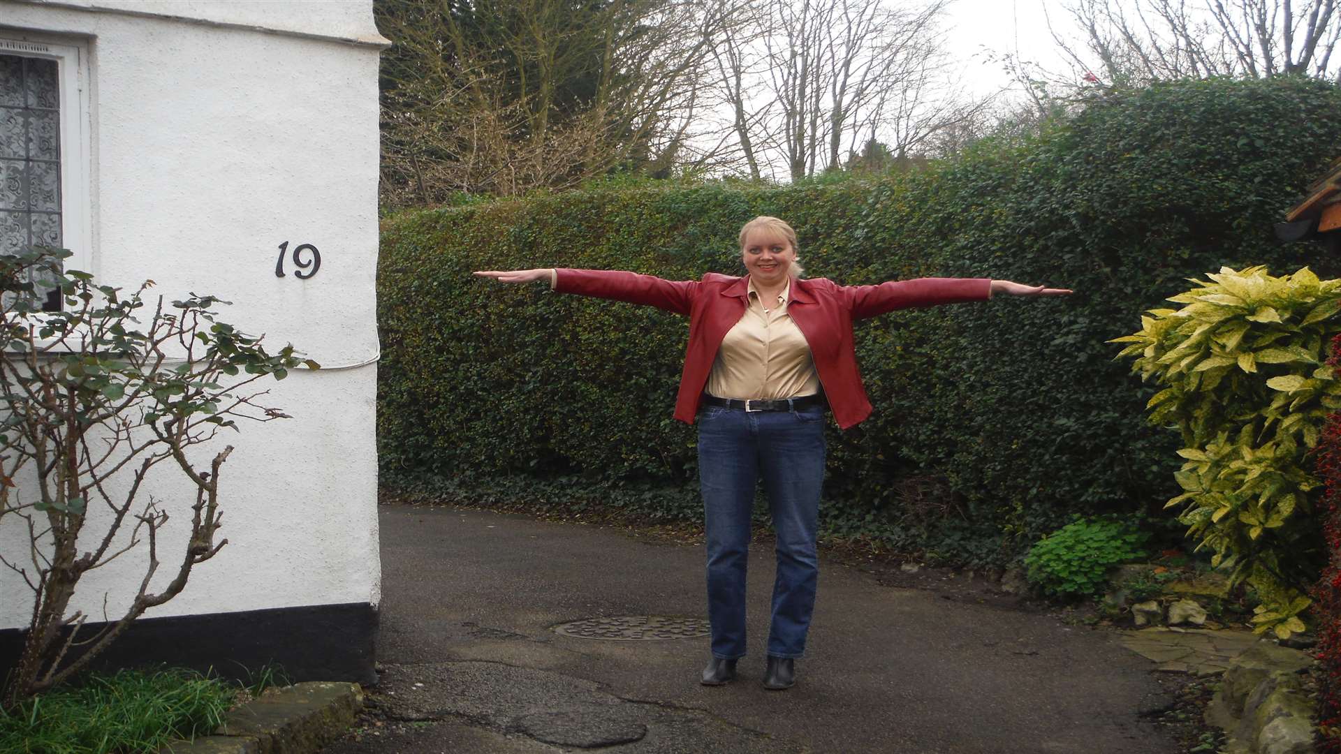 Parish clerk Vicki Smith demonstrates the width of the lane