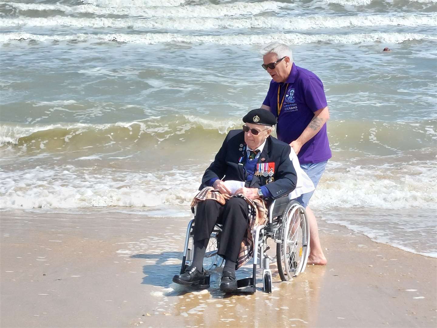 Sittingbourne veteran Roy Smith, also pictured right, with Taxi Charity volunteer Micky Harris on Sword Beach