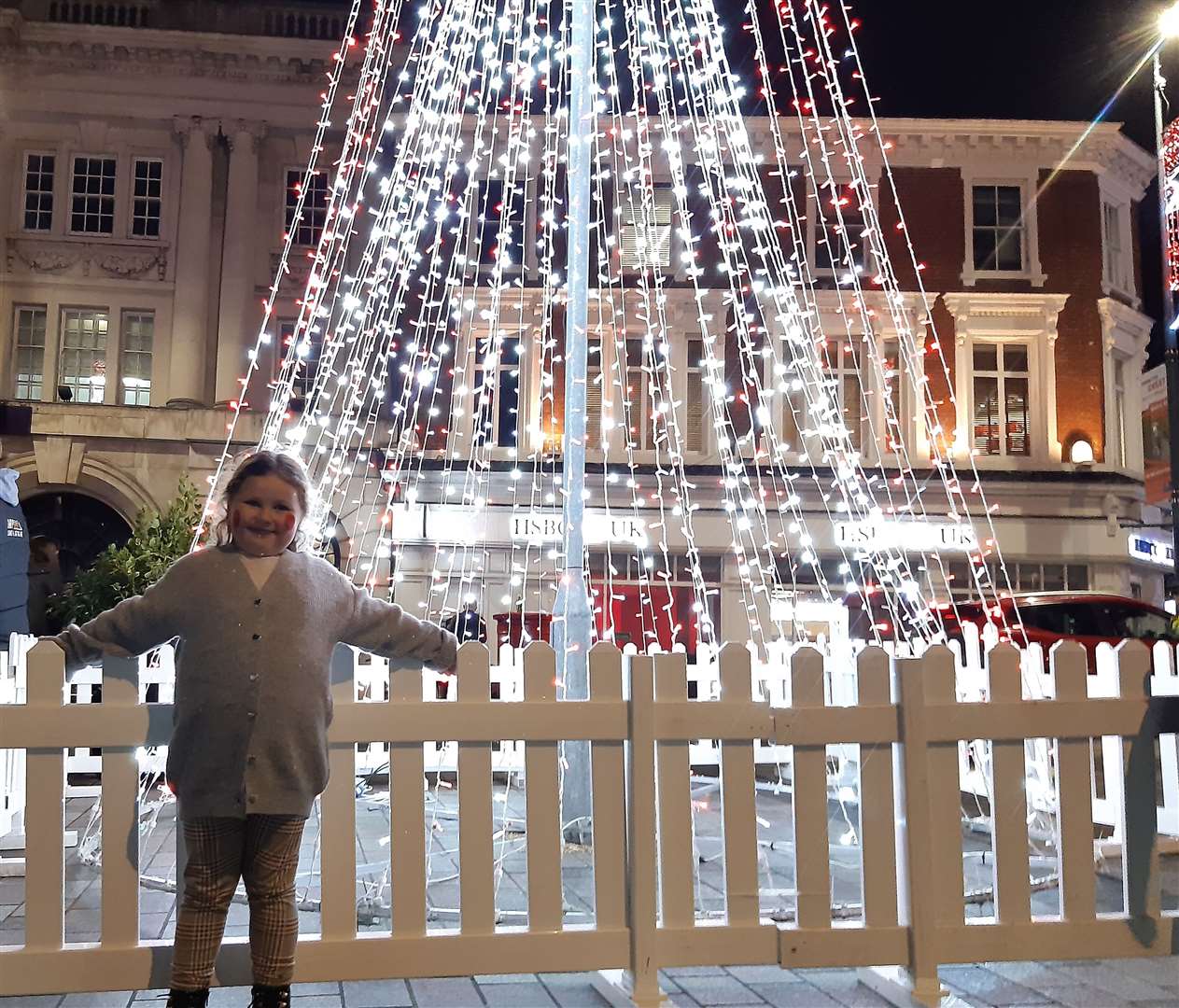 Lottie Bishop, six, standing in front of the Christmas tree in Maidstone after the 2021 lights switch on