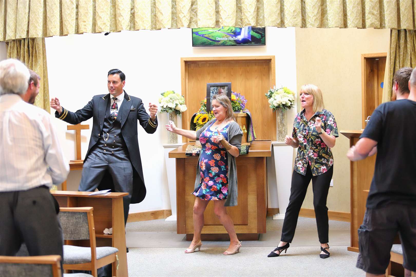 Family and friends performing the Time Warp at the funeral of Dennis Halberg. Photo: W Uden and Sons