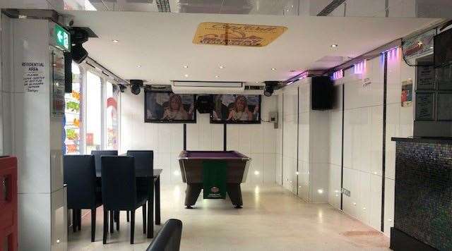 The floor, the walls and the ceiling are white and plain, but there’s also plenty of purple patches to add colour, including the pool table