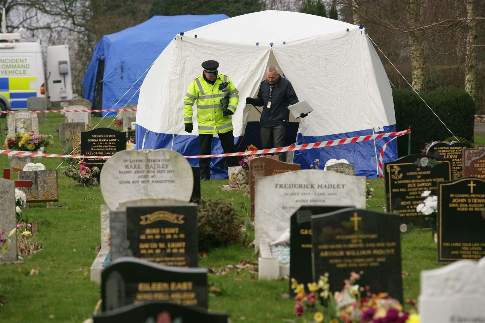 Sgt Gavin Hart and DI Dave Withers emerge from the tent at the grave in 2011. Picture Martin Apps.