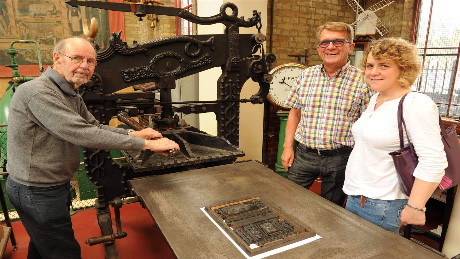 Mike Peevers with Michael Hoyle and Fiona Waddington with the Victorian printing press
