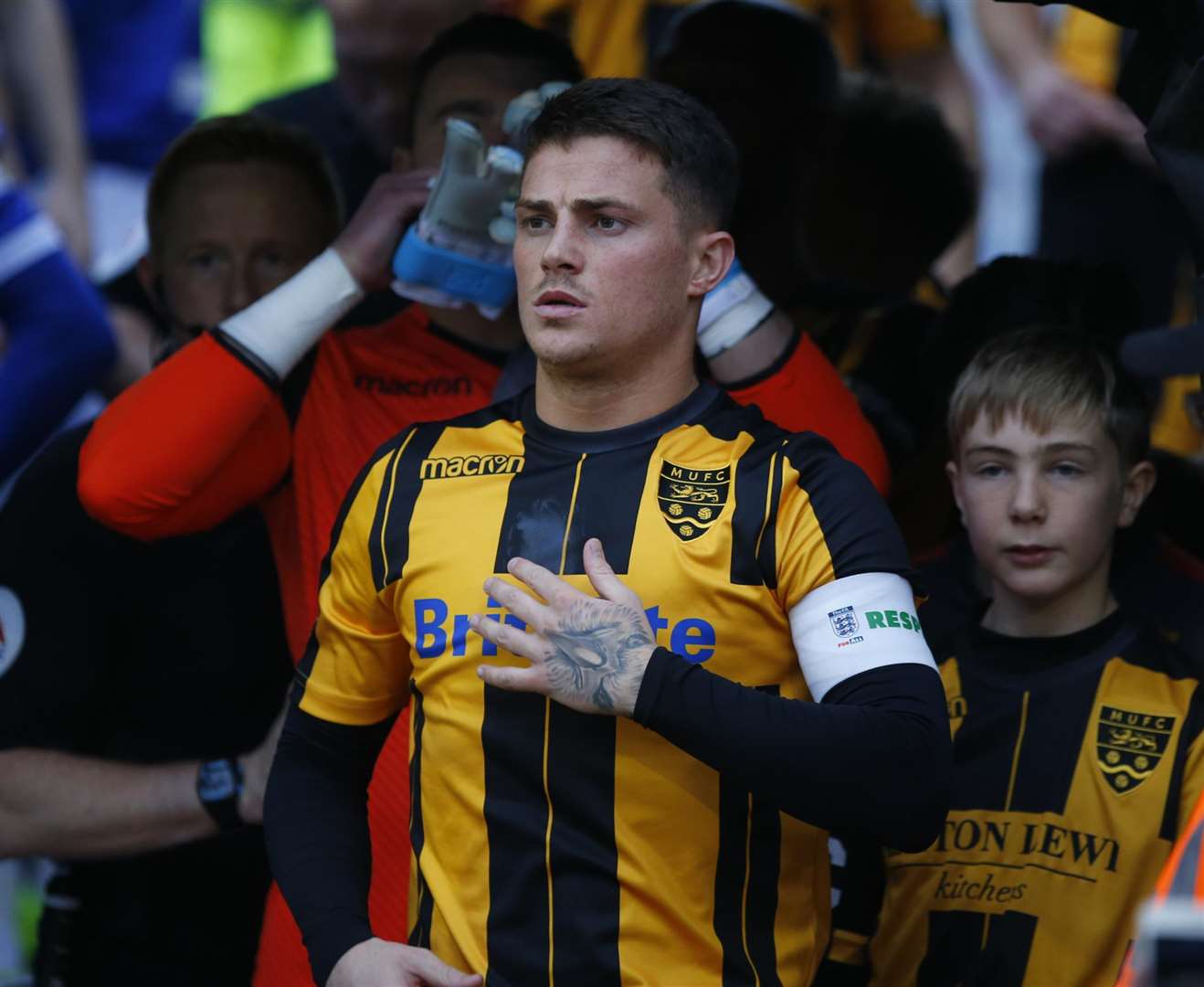 Proud moment for Jack Paxman as he leads out Maidstone for their FA Cup tie against Oldham Picture: Andy Jones