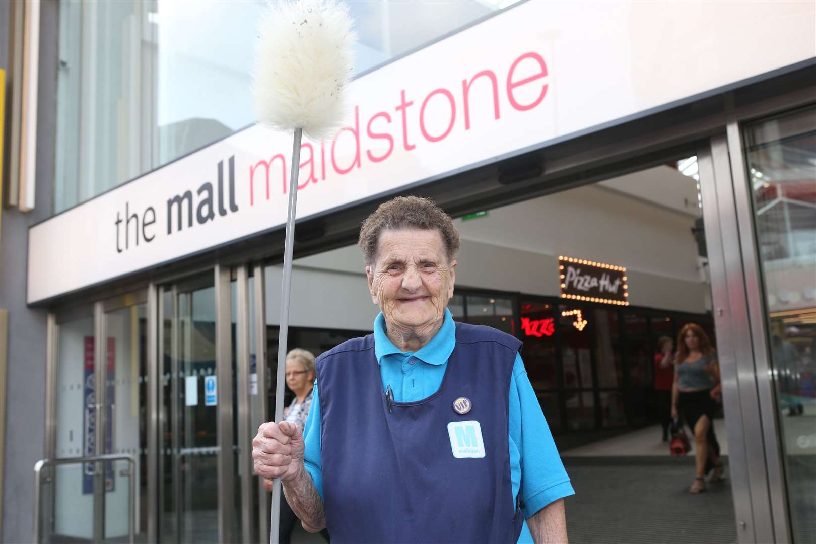 Marjorie is still working at The Mall with duster in hand