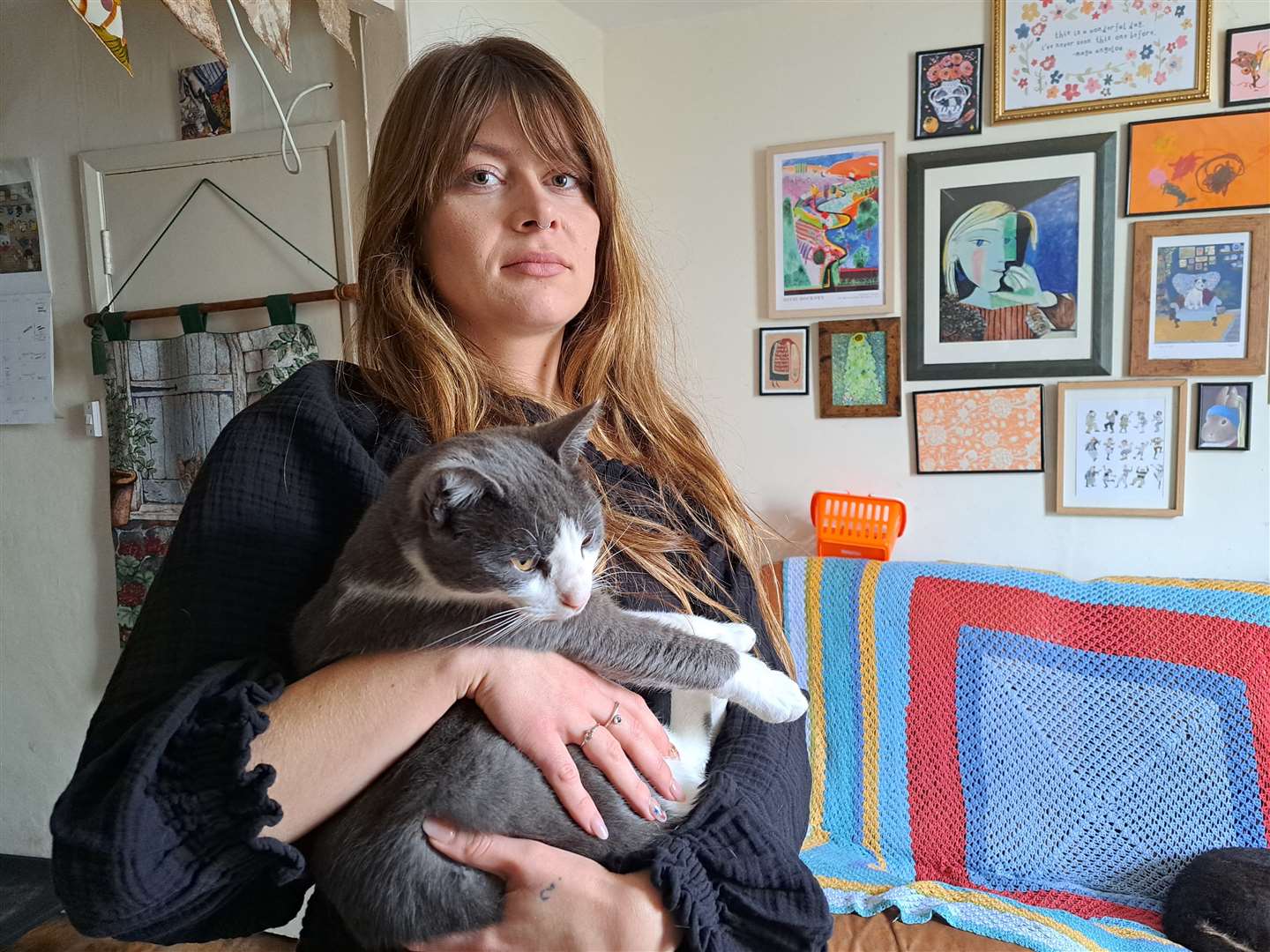Rachel Craft holding her cat Griffin who faced abuse from teenage thugs at Sainsbury's in Canterbury