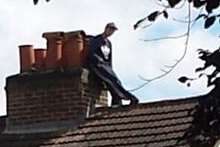 A man on the roof in Quarry Hill Road. Picture: Sam Greenhill