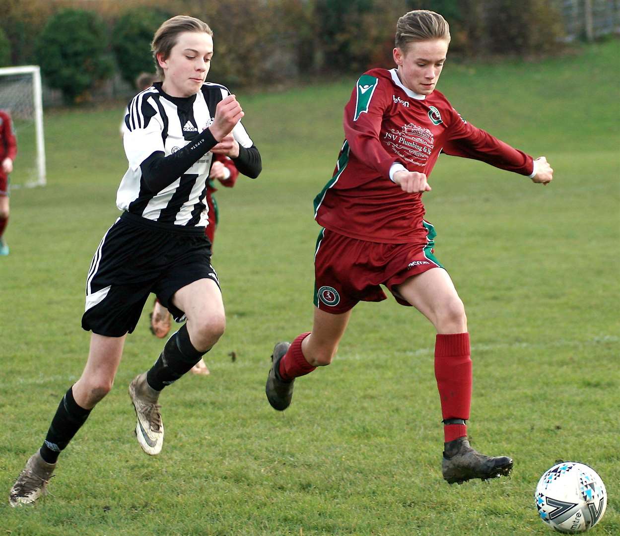 Cobham Colts under-14s (claret) and Real 60 under-14s give chase. Picture: Phil Lee FM22430397