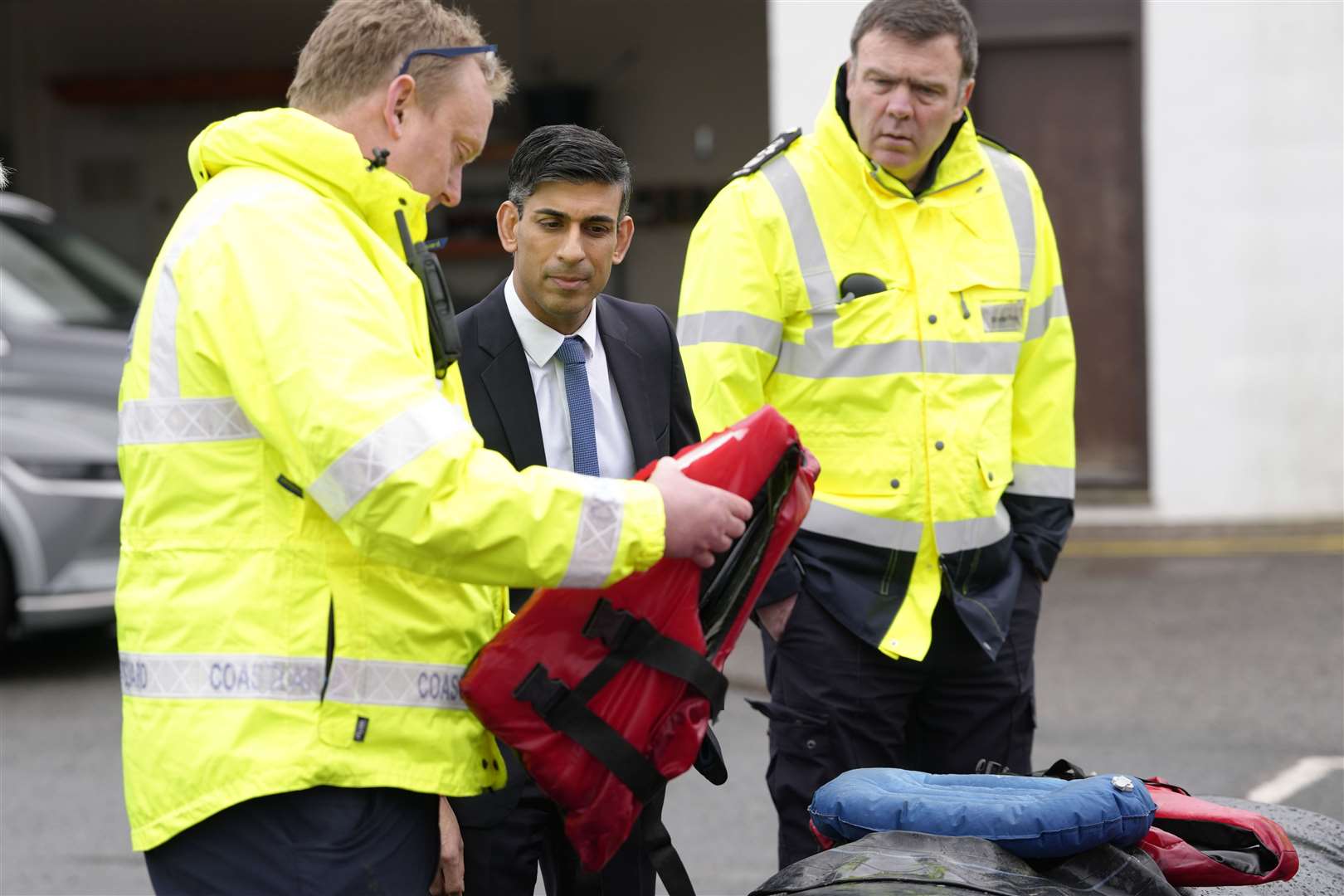Mr Sunak speaks with staff as he views a rubber dinghy and life vests during a visit to the Home Office joint control centre in Dover, Kent (Kirsty Wigglesworth/PA)