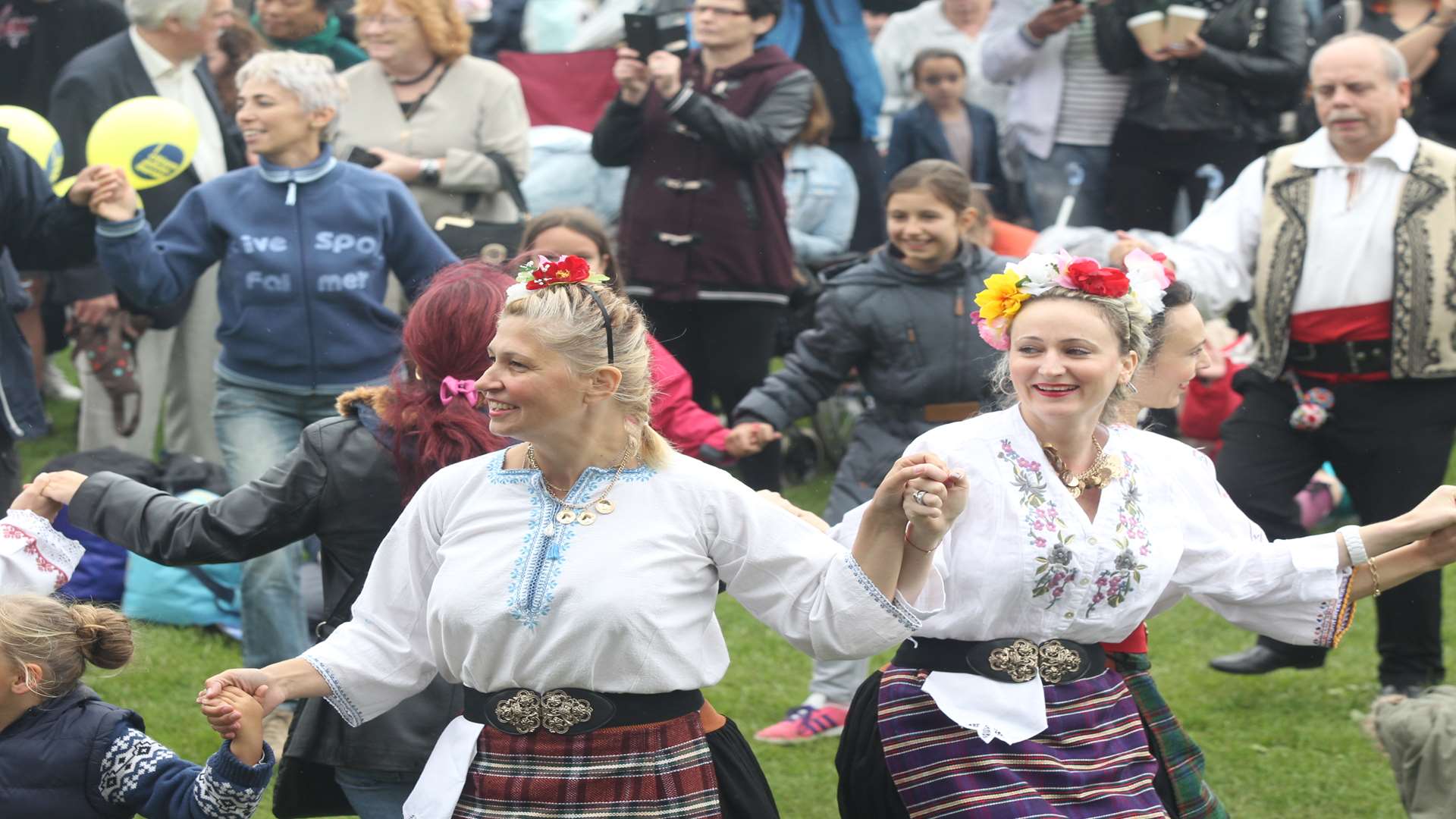 Kitka, a Bulgarian Dance Group perform amongst the public at Maidstone Mela at Mote Park in Maidstone. Picture: John Westhrop.